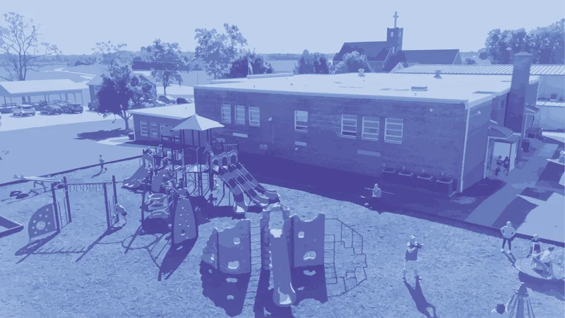 Aerial view of a playground beside a school building