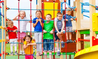 Kids exercising and building physical fitness on playground structures