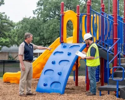 Playground inspection materials being reviewed alongside site conditions.