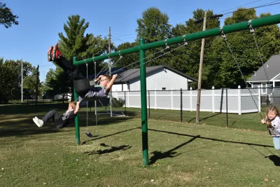 older kids playing on swing set