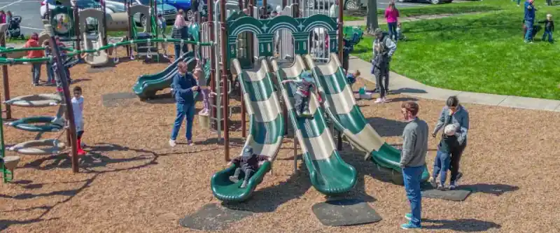Children playing on a commercial playground structure